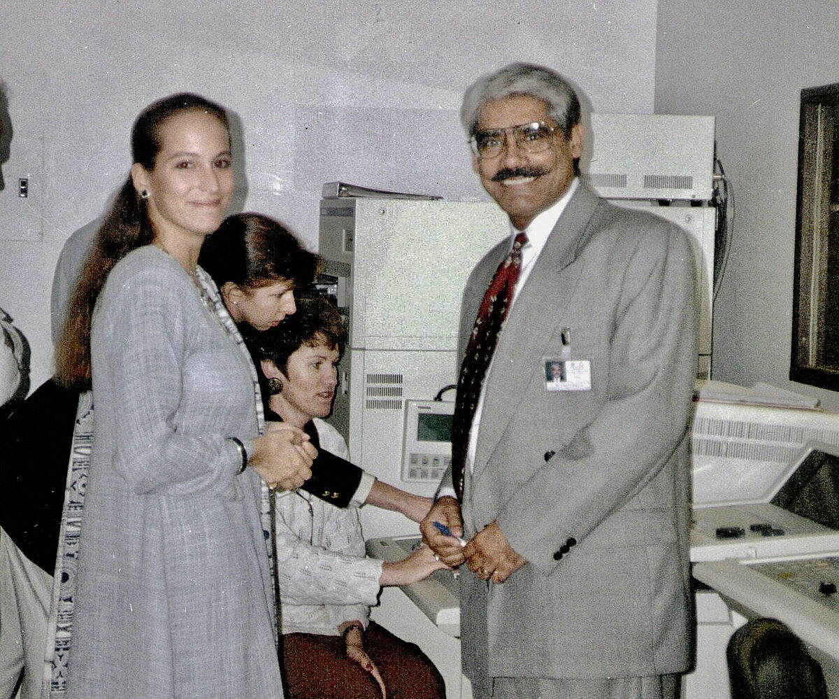 Princess Zahra Aga Khan and Dr. Abdulla, both in grey, the day after the opening, with technicians working on equipment in the background