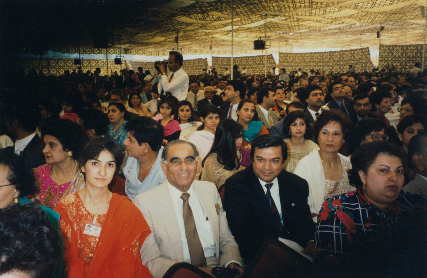 Dr. Abdulla&rsquo;s father, smiling in a light jacket, seated among the audience at the Aga Khan University&rsquo;s tenth-anniversary convocation in Karachi, November 1994