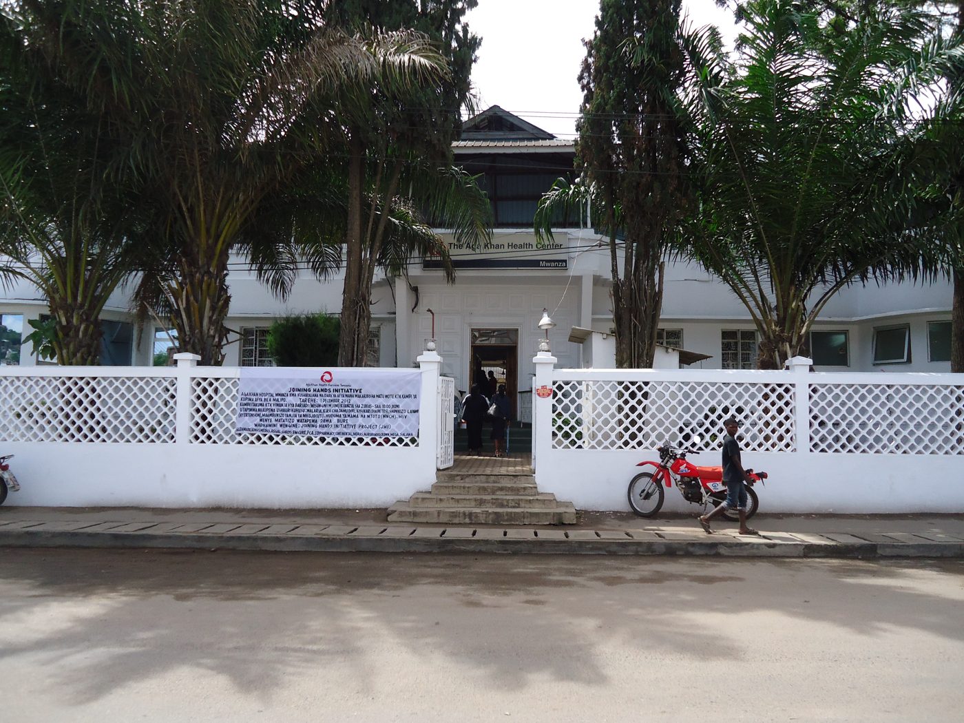 Front of the Aga Khan Health Center, Mwanza, Tanzania, with the banner announcing the Joining Hands Initiative free health screening, 1 December 2012