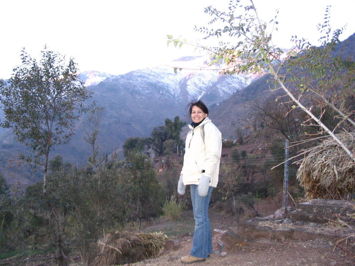 Monique Tremblay above an earthquake-damaged village in the mountains