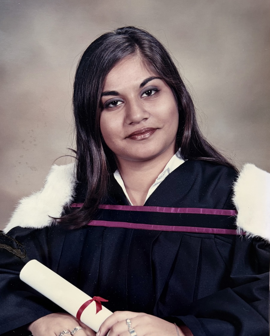 Arifa Abdulla in her McGill University graduation gown, holding her diploma