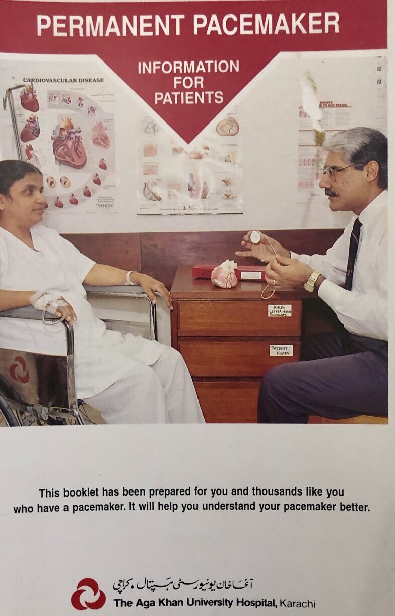 Cover of 'Permanent Pacemaker: Information for Patients,' a patient-education booklet by Dr. Abdulla at the Aga Khan University Hospital, Karachi, showing him explaining a pacemaker to a patient