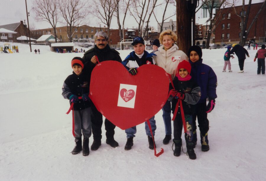 Dr. Abdulla and family with a young congenital heart disease patient and his mother at a Heart Health Program event on the ice, Sudbury