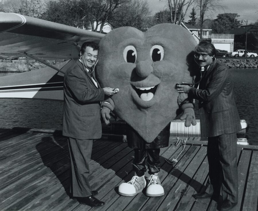 Dr. Abdulla and Regional Chairman Tom Davies examining the Heart Health Program's heart mascot with stethoscopes