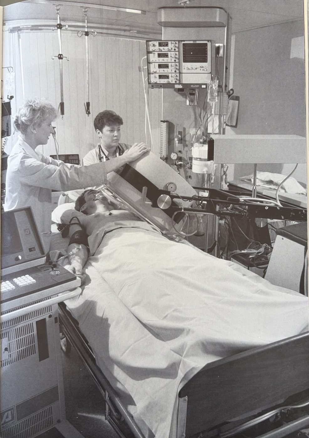 A critically ill patient in the Intensive Care Unit with life-support equipment, imaged with a portable nuclear camera at the bedside